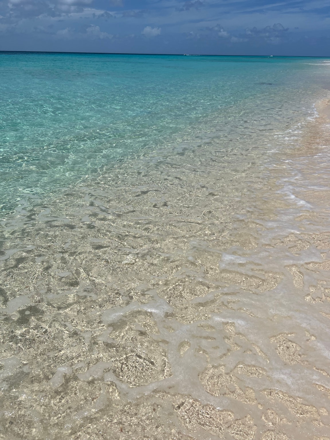 Crystal-clear turquoise water and white sand shoreline